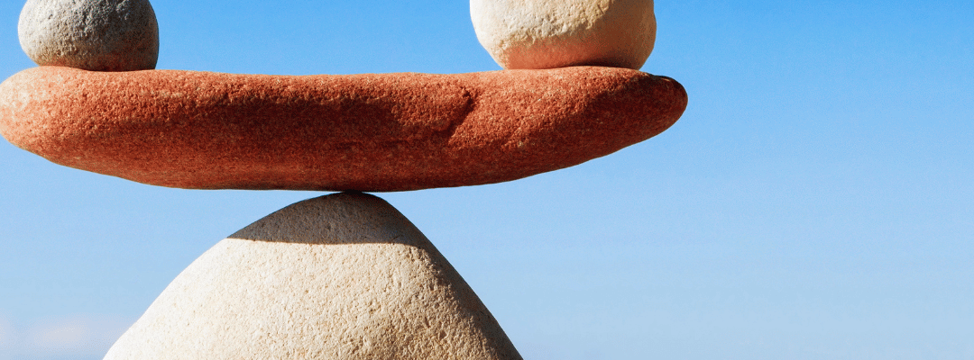 2 stones balancing on another stone